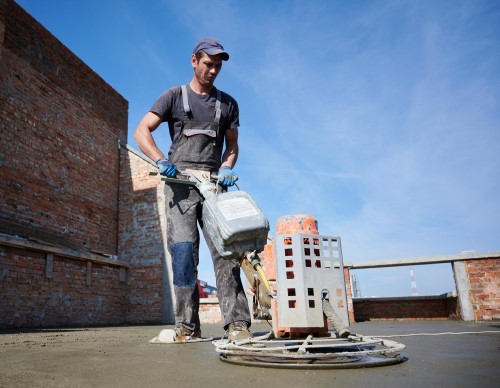 worker-using-power-trowel-machine-construction-site (1)